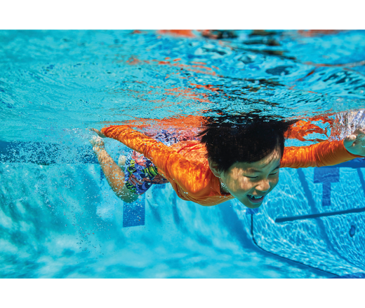 Kid swimming under water.